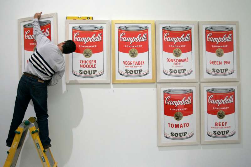 A worker hangs  Campbell's soup,  a print by U.S. artist Andy Warhol, before the opening of the exhibition  Andy Warhol  at Es Baluard museum in Palma de Mallorca on the Spanish island of Mallorca November 29, 2006.
