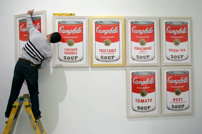 A worker hangs Campbell's soup, a print by U.S. artist Andy Warhol, before the opening of the exhibition Andy Warhol at Es Baluard museum in Palma de Mallorca on the Spanish island of Mallorca November 29, 2006.