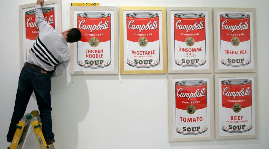 A worker hangs  Campbell's soup,  a print by U.S. artist Andy Warhol, before the opening of the exhibition  Andy Warhol  at Es Baluard museum in Palma de Mallorca on the Spanish island of Mallorca November 29, 2006.