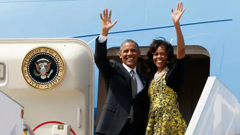 U.S. President Barack Obama and first lady Michelle Obama wave from Air Force One as they depart Dakar, Senegal, June 28, 2013.