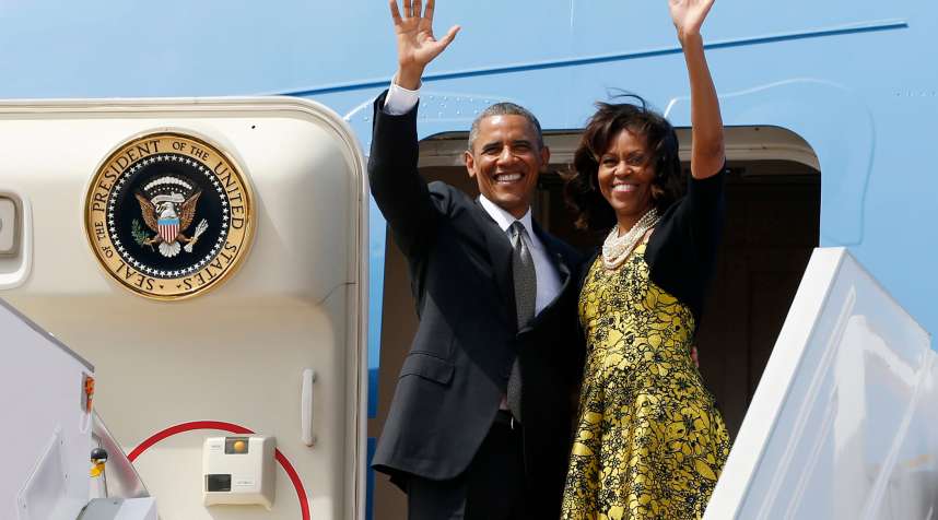 U.S. President Barack Obama and first lady Michelle Obama wave from Air Force One as they depart Dakar, Senegal, June 28, 2013.