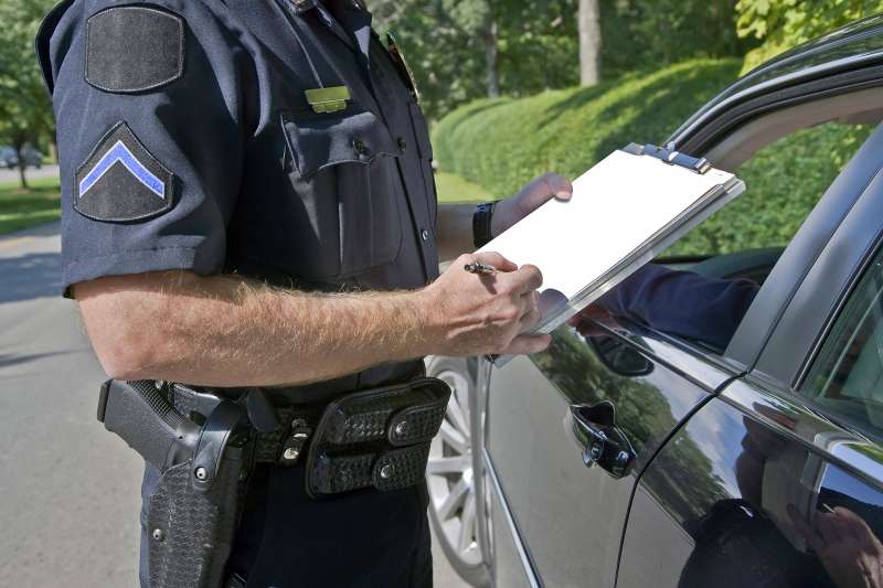 Police Officer writing a speeding ticket
