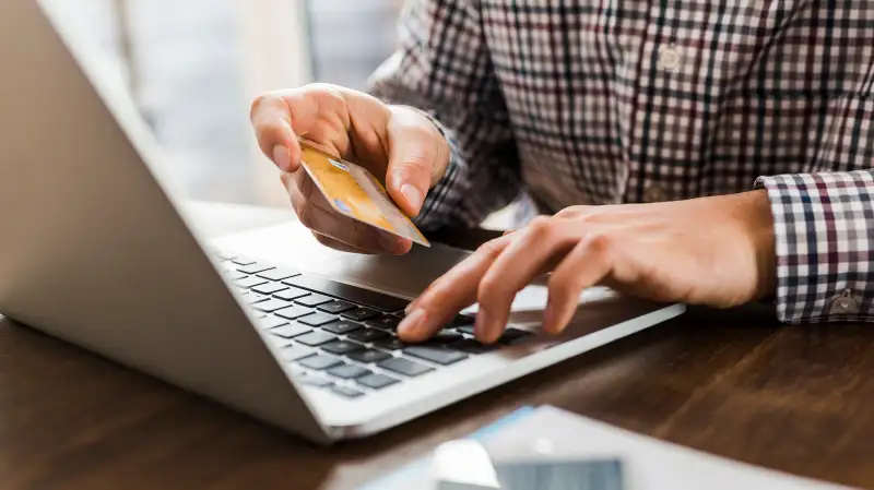 person using laptop to pay by credit card