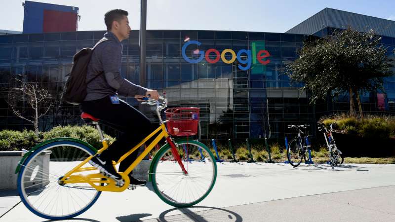 A cyclist rides past Google Inc. offices inside the Googleplex headquarters in Mountain View, California, on February 18, 2016.