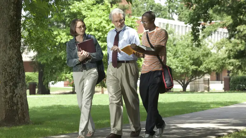 professor walking with students