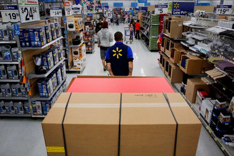 An employee pulls a forklift inside a Wal-Mart location in Los Angeles, on November 24, 2014.
