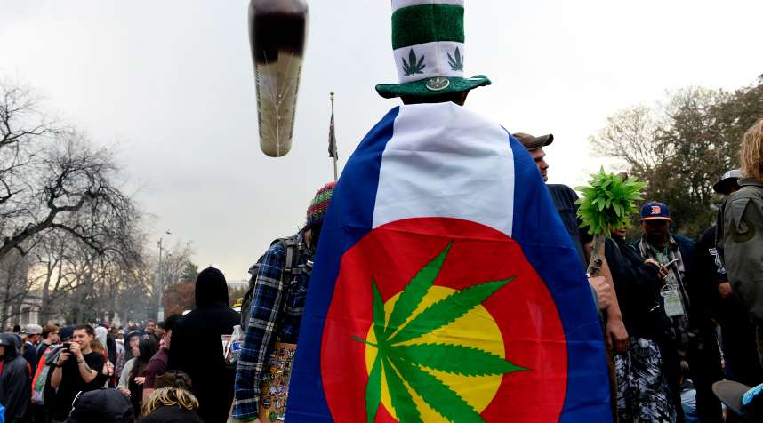 Pot smokers partake in smoking marijuana at exactly 4:20 during the annual 420 celebration in Lincoln Park near the State Capitol in Denver, Colorado  on April 20, 2015.