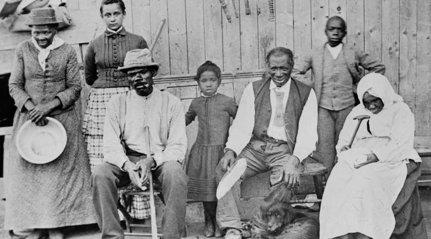 American abolitionist (extreme left, holding a pan), photographed with a group of slaves she helped escape.