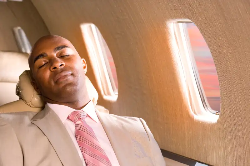 Businessman sleeping in airplane