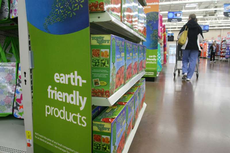In this April 4, 2010 photo, a Wal-Mart customer walks past a line of earth friendly products in the Cincinnati area.