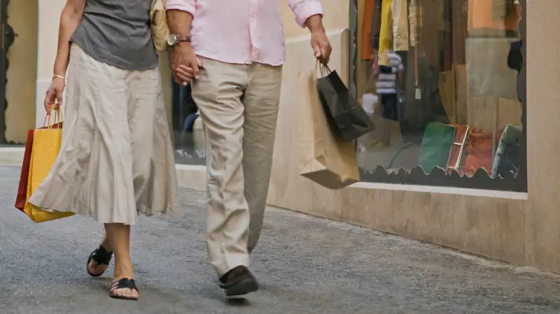 mature couple walking with shopping bags