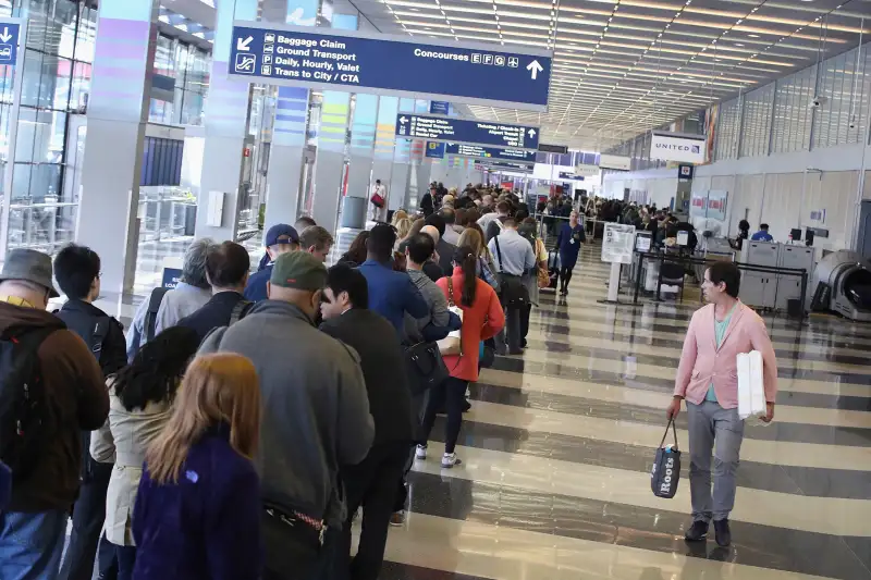 Passengers at O'Hare International Airport wait in line to be screened at a Transportation Security Administration (TSA) checkpoint on May 16, 2016 in Chicago, Illinois. Waiting times at the checkpoints today have been reported to be as long 2 hours. The long lines have been blamed for flight delays and a large number of passengers missing flights completely.