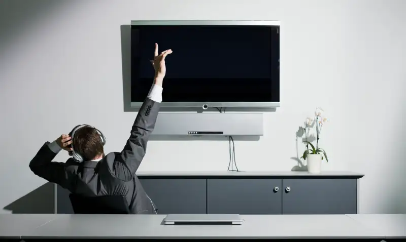 Young businessman with arms raised