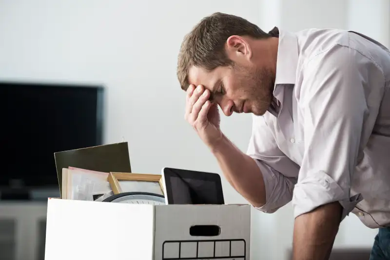 Businessman packing up box in office