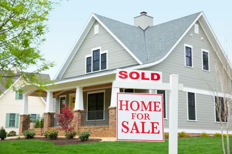 House with sold sign in front yard