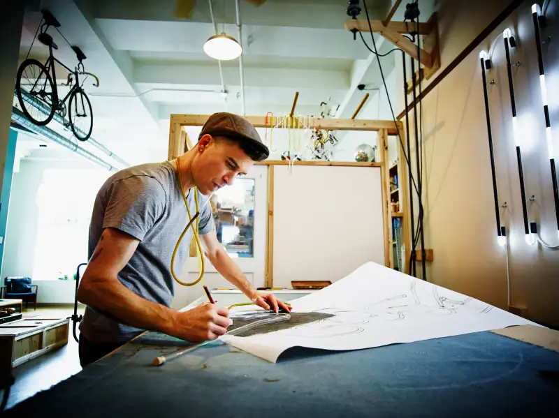Neon artist at work table in industrial loft