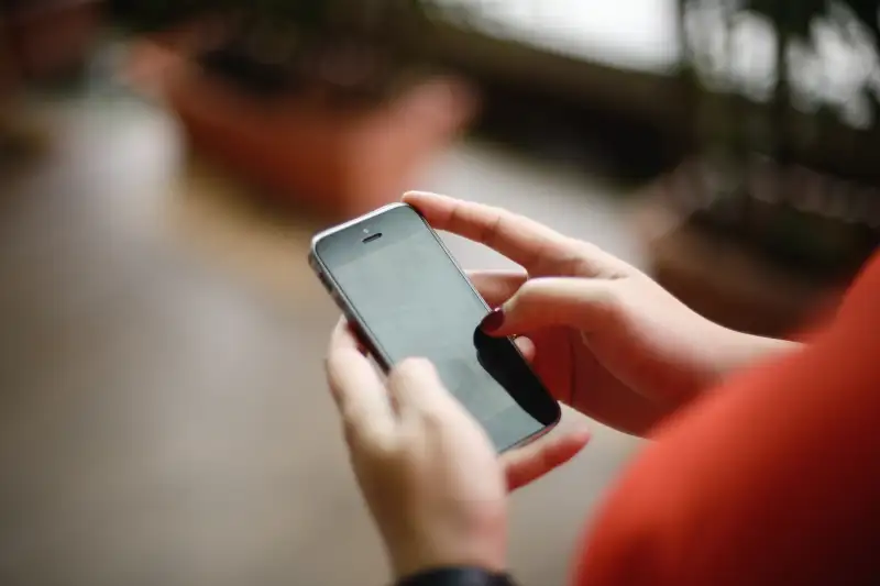 Close up shot of hands using handphone