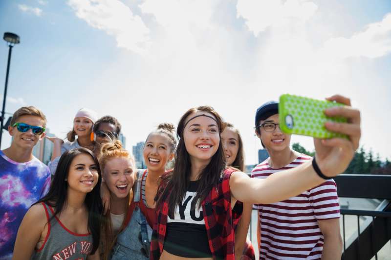 Teenagers taking selfie with camera phone