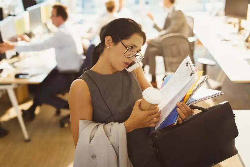 Stressed businesswoman struggling to multitask in office