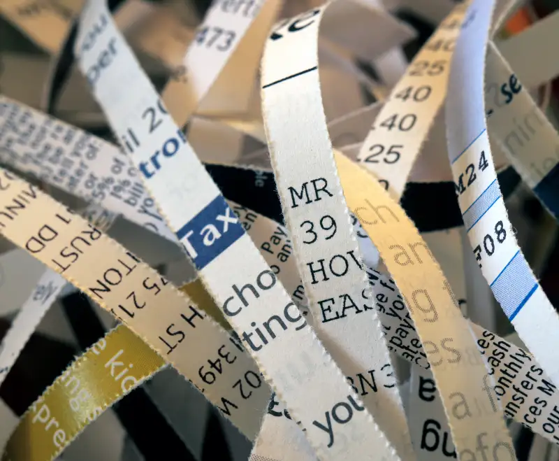 Shredded personal documents including bank statements, tax details and addresses, destroyed for security reasons to avoid identity theft. UK