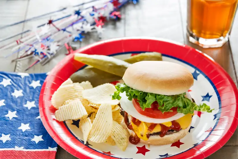 Cheeseburger loaded with toppings in a patriotic theme