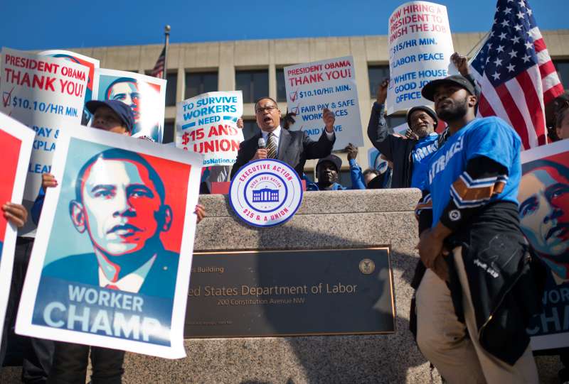 Workers protest at an April rally on the steps the Department of Labor to call for the minimum wage be raised to $15 per hour.