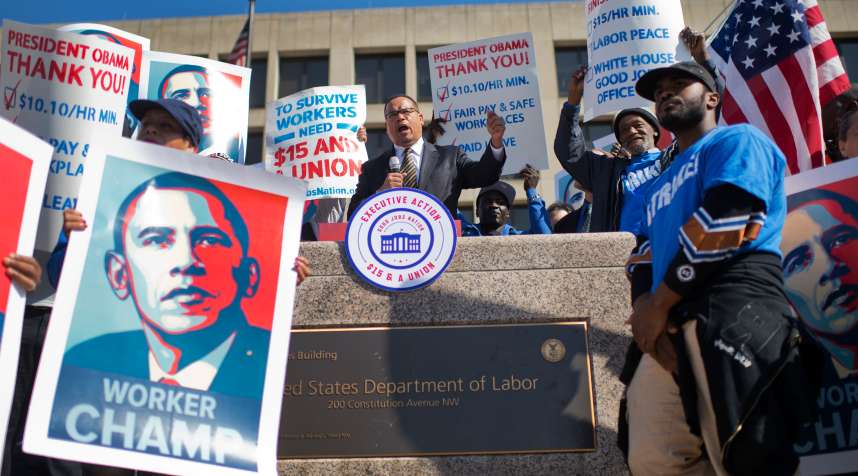 Workers protest at an April rally on the steps the Department of Labor to call for the minimum wage be raised to $15 per hour.