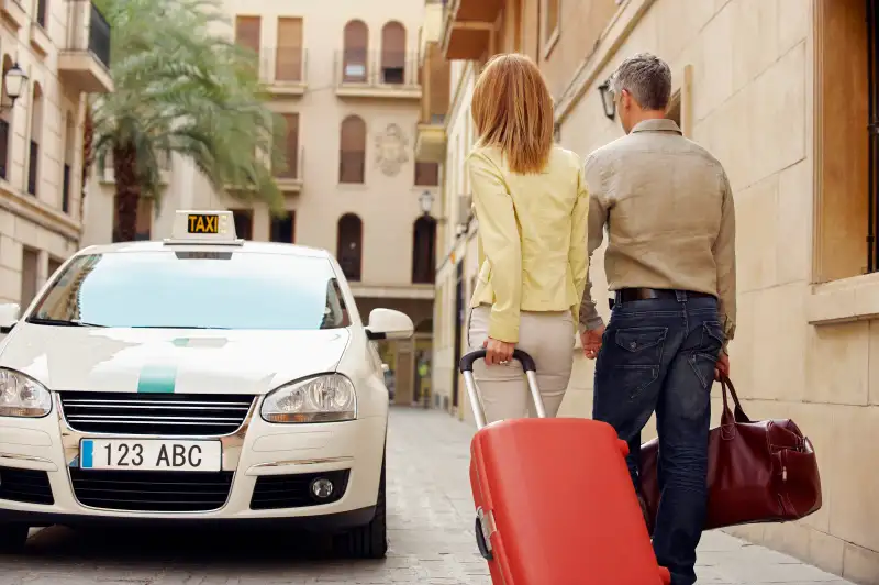 Couple walking towards taxi