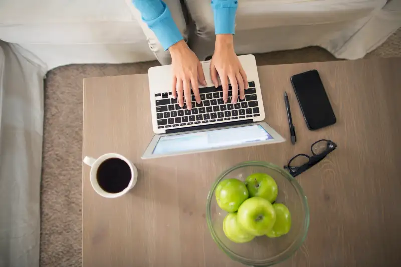 Top view of woman working on a lap top