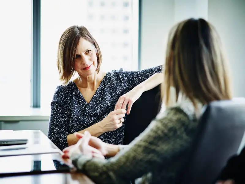 Mature businesswoman in discussion with colleague