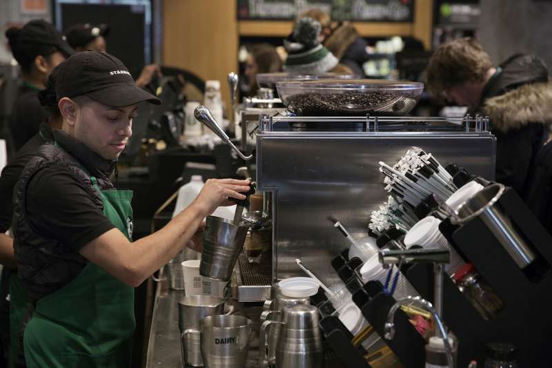 A barista froths milk for a drink inside a Starbucks Corp. coffee shop in New York, on January 18, 2016.