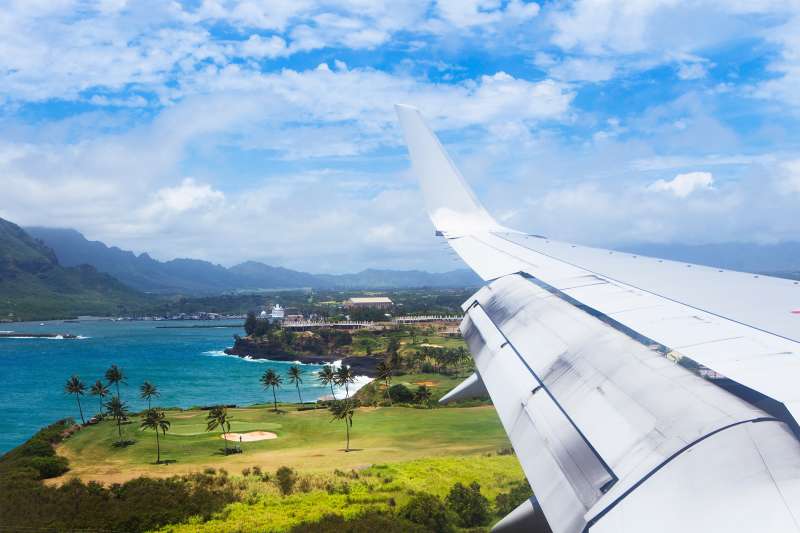 A plane flies into Lihue airport on Kauai.