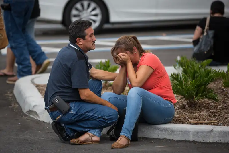 Friends and family grieve after a list of hospitalized victims was released, implying the death of those who weren't on the list and hadn't been heard from, outside a Hampton Inn & Suites hotel near the Orlando Regional Medical Center in Orlando, Fla., Sunday, June 12, 2016. A gunman opened fire inside a crowded nightclub early Sunday, before dying in a gunfight with SWAT officers, police said.