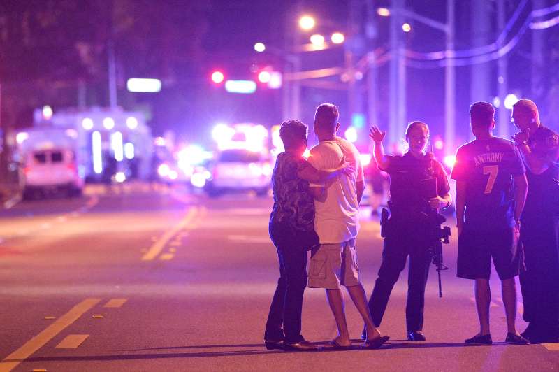 Orlando Police officers direct family members away from a fatal shooting at Pulse Orlando nightclub in Orlando, Florida, June 12, 2016.