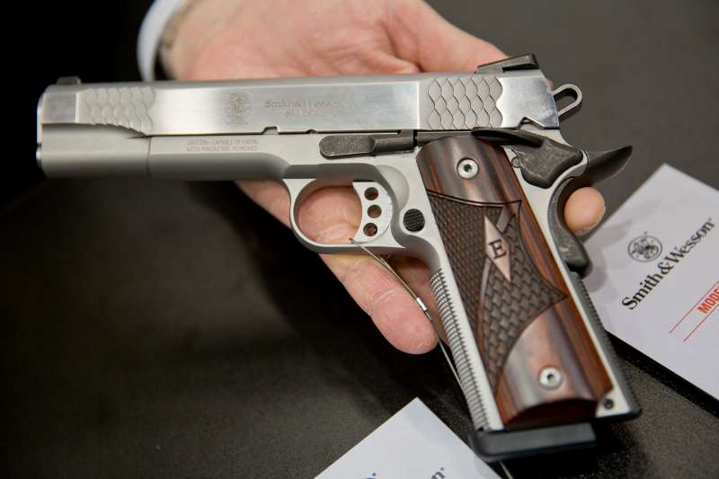 A man holds up a SW1911 pistol from US American arms manufacturer Smith &amp; Wesson, March 5, 2016.