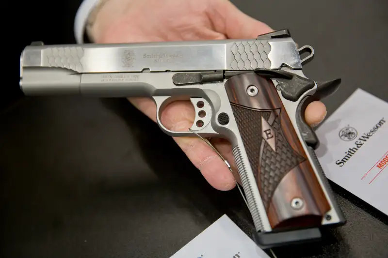 A man holds up a SW1911 pistol from US American arms manufacturer Smith & Wesson, March 5, 2016.