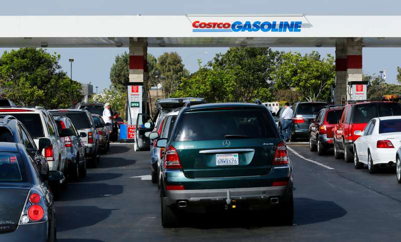 People line up to purchase gasoline at a Costco Gas Station in Carlsbad, California, October 5, 2012.