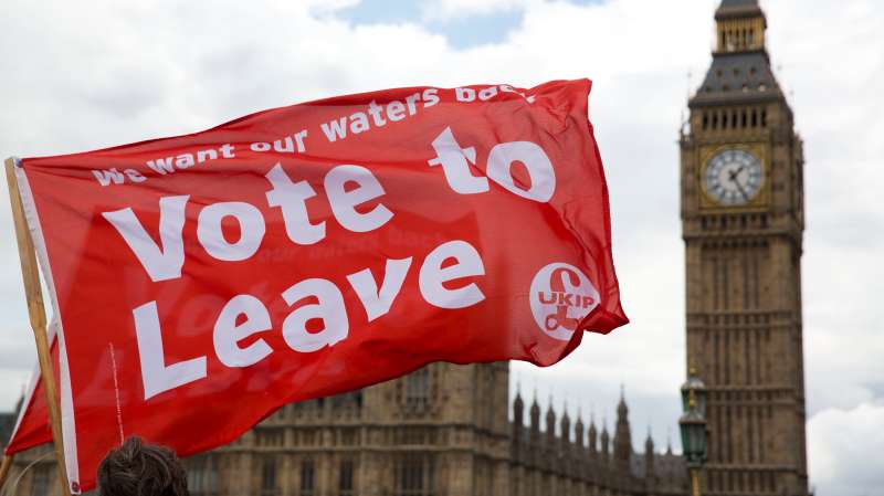 Leave supporters hold flags as they stand on Westminster Bridge during an EU referendum campaign stunt in which a flotilla of boats supporting  Leave  sailed up the River Thames outside the Houses of Parliament in London, Wednesday, June 15, 2016. A flotilla of boats protesting EU fishing polices has sailed up the River Thames to the Houses of Parliament as part of a campaign backing Britain's exit from the European Union. The flotilla was greeted by boats carrying  remain  supporters.