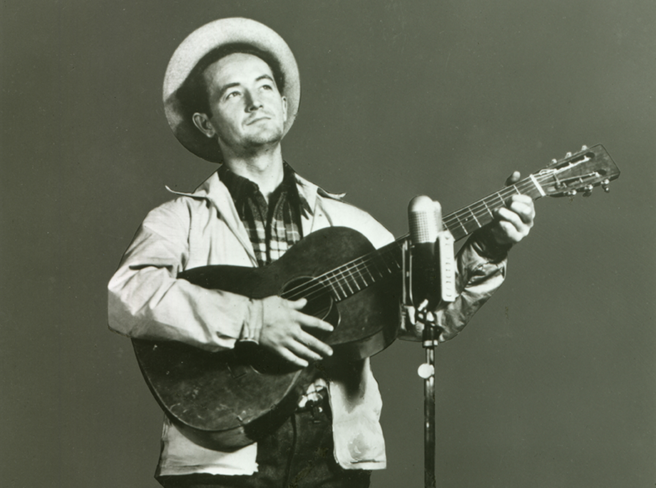 Woody Guthrie performing on “Back Where I Come From” radio show, WABC-CBS. New York City, 1940.
