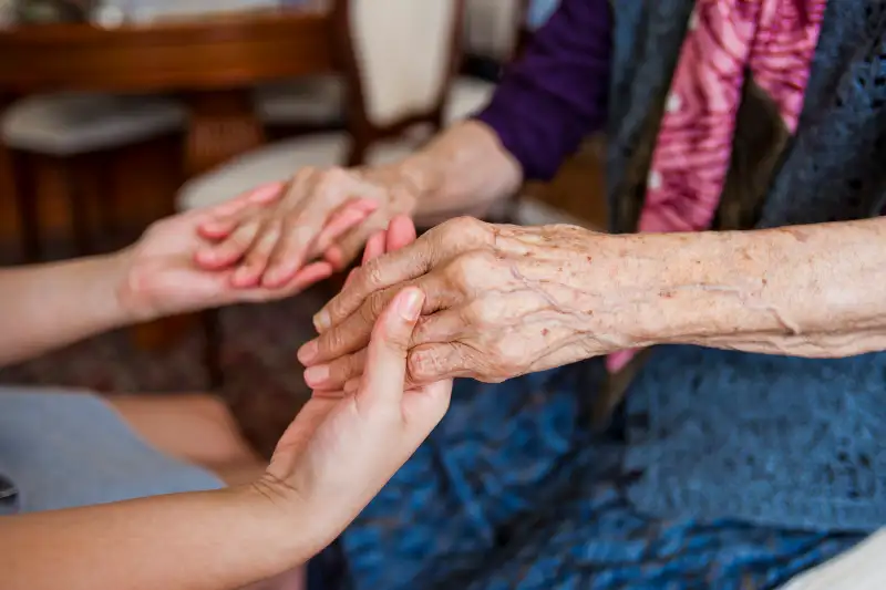 holding seniors hands