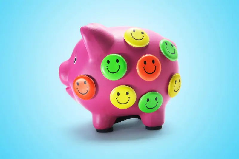 piggy bank with smiley buttons all over it