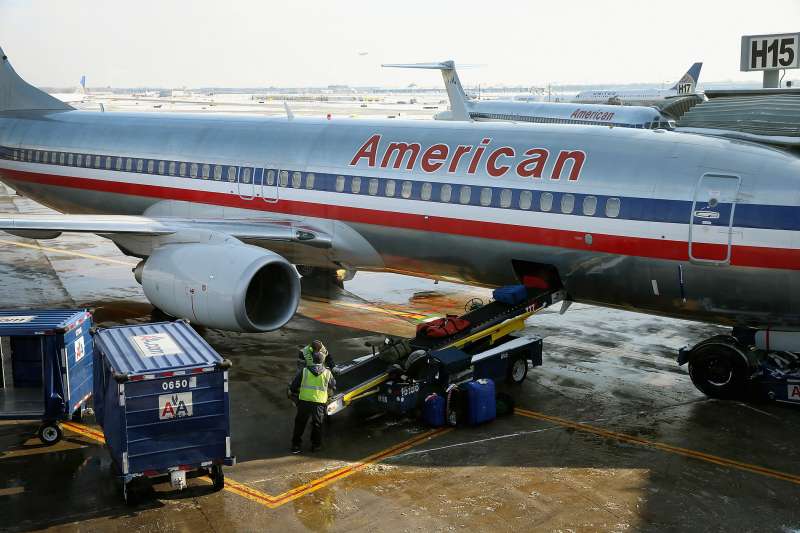 Luggage is loaded on to an American Airlines jet as it is prepared for a flight at O'Hare Airport.