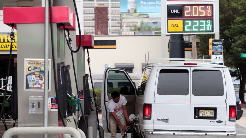 A motorist finishes pumping gas into a van at a gas station in downtown Newark, N.J., June 28, 2016.