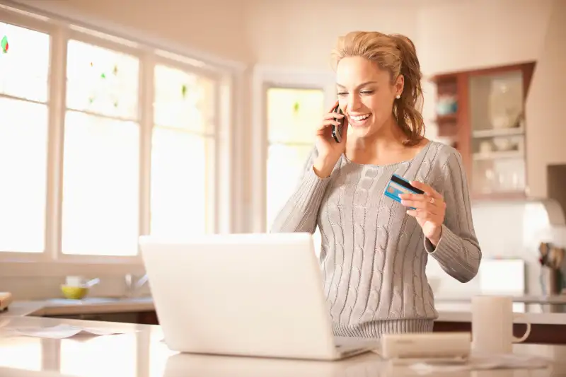 Hispanic woman shopping online with credit card