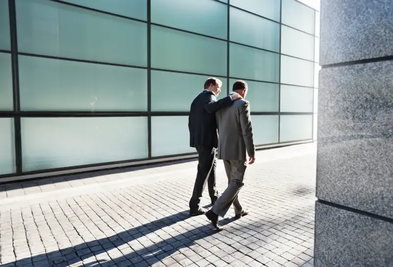 Businessmen talking on city street