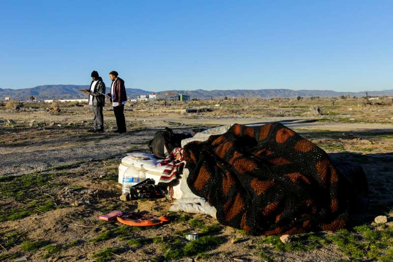 Derrick Chambers checks out a homeless encampment in an open area of Southern part of Lancaster while documenting their number in the area on January 28, 2016.