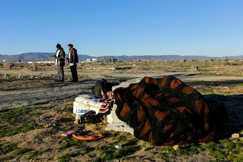 Derrick Chambers checks out a homeless encampment in an open area of Southern part of Lancaster while documenting their number in the area on January 28, 2016.