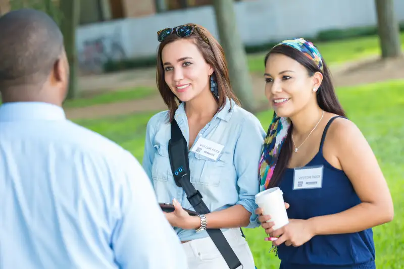 Prospective college students taking campus tour with guide