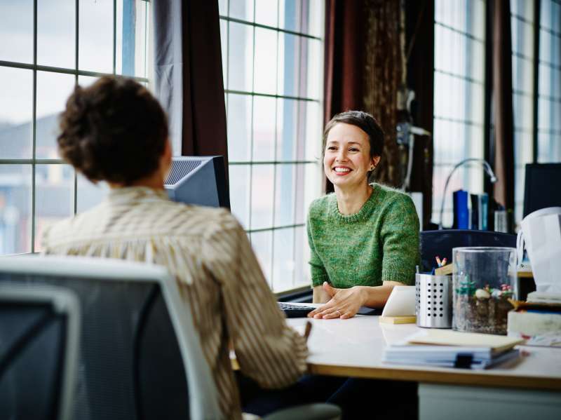 Smiling business owners at workstation in office