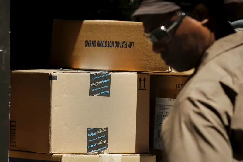 A UPS worker organizes Amazon boxes to be delivered in New York July 24, 2015.